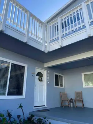 a porch of a house with two chairs in front of it at Blue Whale Inn Pet and Kid Friendly Unit C in San Clemente