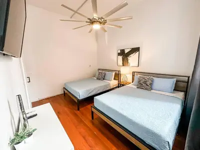 a room with two beds and a ceiling fan at 2BR Walk to Convention Center Free Parking in San Diego