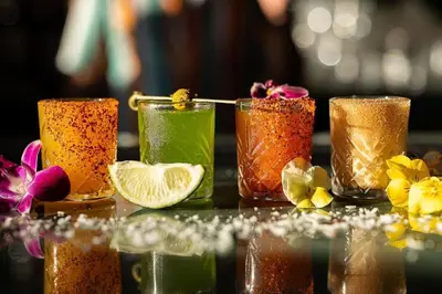 a group of four glasses filled with different colored drinks at 2BR Downtown Suite Free Parking - Conv Center in San Diego