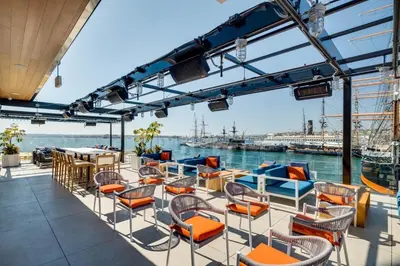 a deck on a ship with chairs and tables at 2BR Downtown Suite Free Parking - Conv Center in San Diego