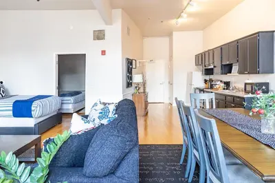a living room and kitchen with a couch and a table at Top Floor Conv Center Free Parking 4 Beds in San Diego