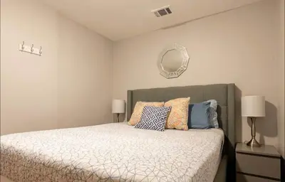 a bedroom with a bed with pillows and a mirror at Free Parking Cozy 1BR in Gaslamp Conv Center in San Diego