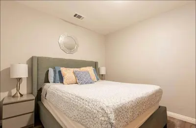 a bedroom with a bed and a mirror on the wall at Free Parking Cozy 1BR in Gaslamp Conv Center in San Diego