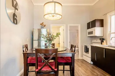 a kitchen with a table with chairs and a refrigerator at Free Parking Cozy 1BR in Gaslamp Conv Center in San Diego