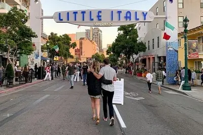 a man and a woman walking down a street at Free Parking Cozy 1BR in Gaslamp Conv Center in San Diego