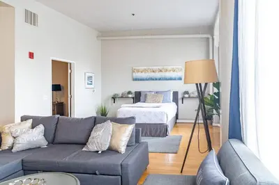 a living room with a couch and a bed at Top Floor Walk to Conv Center Free Parking in San Diego