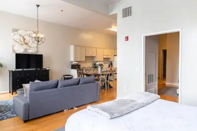 a living room with a couch and a kitchen at Top Floor Walk to Conv Center Free Parking in San Diego