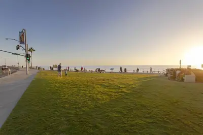 a group of people walking on the beach at Luxury Ocean Views & Steps To The Sand - Tower 36 Lower Condo Unit in Carlsbad