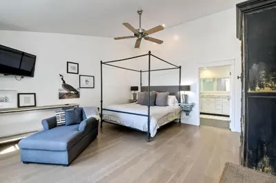 a bedroom with a canopy bed and a couch at Luxury Ocean Views & Steps To The Sand - Tower 36 Lower Condo Unit in Carlsbad