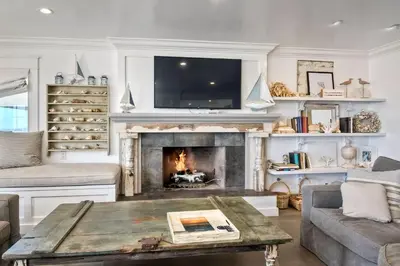 a living room with a fireplace and a tv at Luxury Ocean Views & Steps To The Sand - Tower 36 Lower Condo Unit in Carlsbad