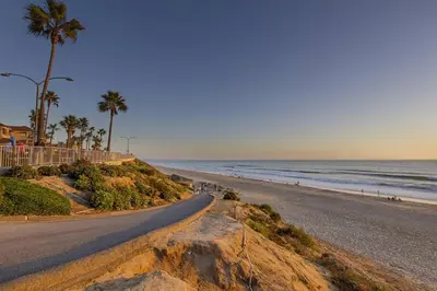 a road leading to a beach with palm trees and the ocean at Walk to Beach, AC, Firepit, Grill in Carlsbad
