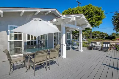 a patio with a table and an umbrella at Walk to Beach, AC, Firepit, Grill in Carlsbad