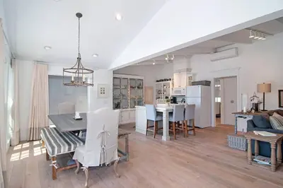 a dining room and living room with a table and chairs at Walk to Beach, AC, Firepit, Grill in Carlsbad