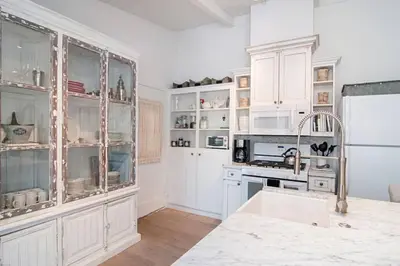 a kitchen with white cabinets and a white refrigerator at Walk to Beach, AC, Firepit, Grill in Carlsbad