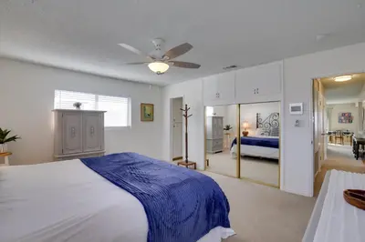 a bedroom with a bed with a blue blanket on it at Oceanfront Escape Steps to Imperial Beach! in Imperial Beach