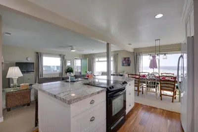 a kitchen with white cabinets and a stove top oven at Oceanfront Escape Steps to Imperial Beach! in Imperial Beach