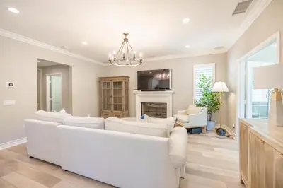 a living room with a white couch and a fireplace at @ Marbella Lane - Modern and Sophisticated Home in Irvine
