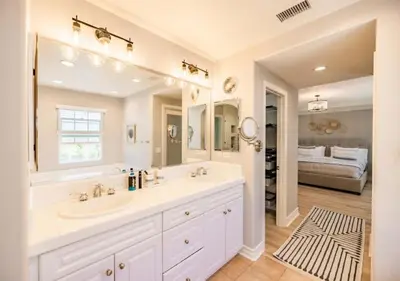 a bathroom with a sink and a large mirror at @ Marbella Lane - Modern and Sophisticated Home in Irvine