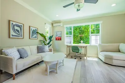 a living room with a couch and a table and a desk at @ Marbella Lane - Modern and Sophisticated Home in Irvine