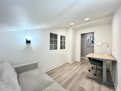 a living room with a couch and a desk at @ Marbella Lane - Modern and Sophisticated Home in Irvine