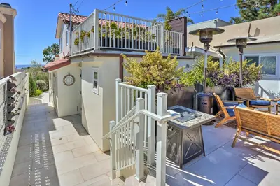 a house with a balcony and a patio at Luxe Laguna Home with Ocean View Walk to Beach in Laguna Beach