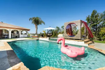 a swimming pool with a pink flamingos in the water at MAGIC VILLA Overlooking Pool Oasis in Temecula