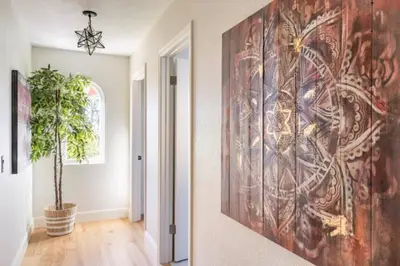 a hallway with a large painting on the wall at MAGIC VILLA Overlooking Pool Oasis in Temecula