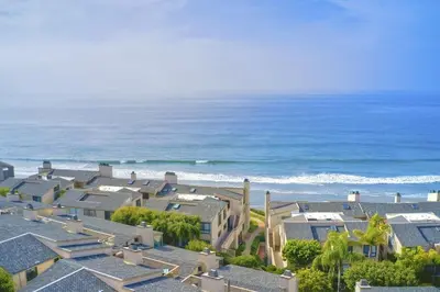 a group of houses on the beach near the ocean at Oceanfront Luxury, Fully Remodeled, Five-Star in Solana Beach
