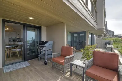 a patio with two chairs and a grill on a house at Oceanfront Luxury, Fully Remodeled, Five-Star in Solana Beach