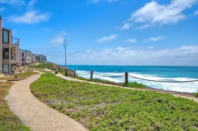 a path leading to a beach with the ocean at Oceanfront Luxury, Fully Remodeled, Five-Star in Solana Beach