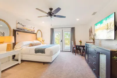 a bedroom with a bed and a ceiling fan at Villa Inn- Adult Only- Temecula Wine Country in Temecula