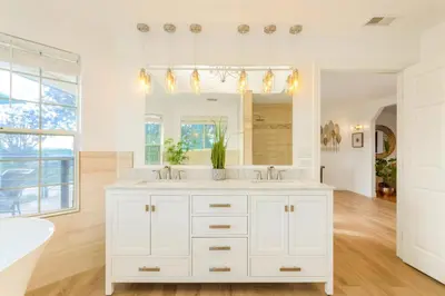 a white bathroom with a white sink and a tub at Villa Inn- Adult Only- Temecula Wine Country in Temecula