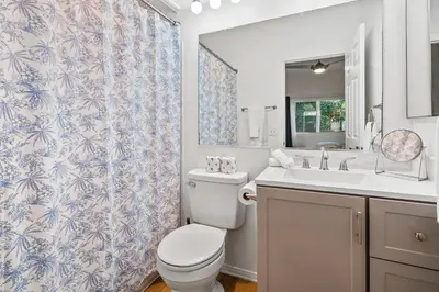 a bathroom with a toilet and a sink at Life on the Point in San Diego