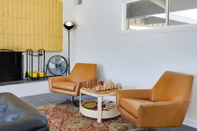 a living room with two chairs and a chessboard on a table at Borrego Springs Retreat with Pool and Mtn Views in Borrego Springs