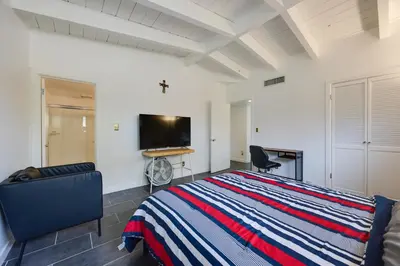 a bedroom with a bed and a flat screen tv at Borrego Springs Retreat with Pool and Mtn Views in Borrego Springs