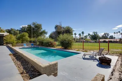 a swimming pool with a table and a chair next to it at Borrego Springs Retreat with Pool and Mtn Views in Borrego Springs