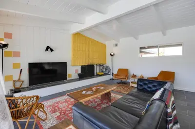 a living room with a couch and a tv at Borrego Springs Retreat with Pool and Mtn Views in Borrego Springs