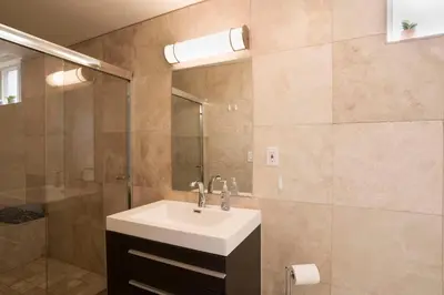 a bathroom with a sink and a shower at Architectural Gem La Jolla Oceanview surf and golf in San Diego