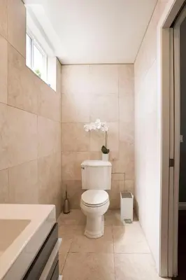 a bathroom with a toilet and a sink at Architectural Gem La Jolla Oceanview surf and golf in San Diego