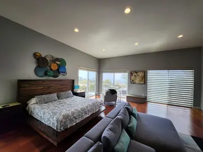 a bedroom with a bed and a couch at Architectural Gem La Jolla Oceanview surf and golf in San Diego
