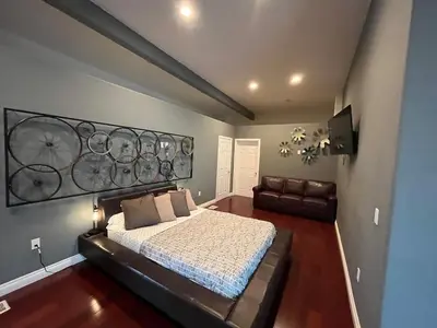 a bedroom with a large bed and a couch at Architectural Gem La Jolla Oceanview surf and golf in San Diego