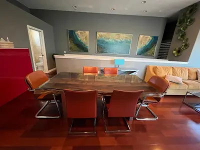 a dining room with a table and chairs and a couch at Architectural Gem La Jolla Oceanview surf and golf in San Diego