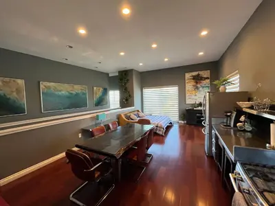 a living room with a table and a couch at Architectural Gem La Jolla Oceanview surf and golf in San Diego