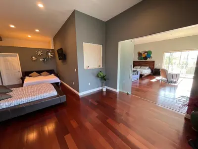 a bedroom with two beds and a living room at Architectural Gem La Jolla Oceanview surf and golf in San Diego