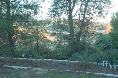 a view of a hill with trees and a fence at Wondrous Stays in Temecula