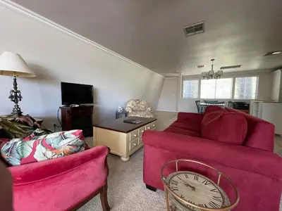 a living room with a red couch and a clock at Wondrous Stays in Temecula