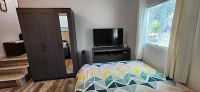 a bedroom with a bed and a flat screen tv at New ! Lovely Studio w/ patio, Parking on premises in Escondido