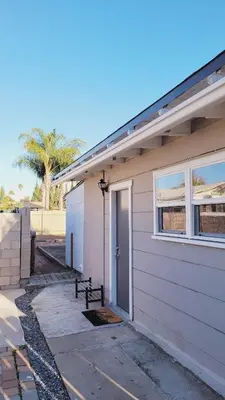 a white house with a door and a window at New ! Lovely Studio w/ patio, Parking on premises in Escondido