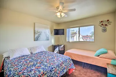 a bedroom with a bed and a ceiling fan at Breeze By the Pool Chula Vista Home with Game Room in Chula Vista
