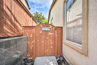 a wooden gate on the side of a building with a window at Chula Vista Studio with Hot Tub about 9 Mi to Downtown in Chula Vista